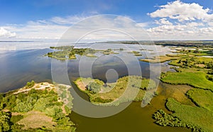 Aerial view of islands with lush greenery in a freshwater river in summer. European landscape