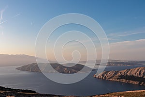 Aerial view of isolated Otok Prvic seen from mountain top Hlam in Baska, Krk Island, Primorje-Gorski Kota