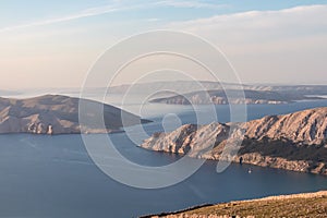 Aerial view of isolated Otok Prvic seen from mountain top Hlam in Baska, Krk Island, Primorje-Gorski Kota