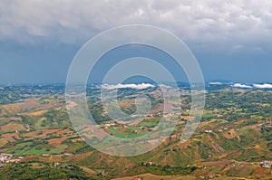 Aerial view of Italian countryside with farm fields and hills