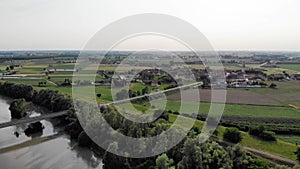 Aerial view with an Italian village located on the bank of a river.