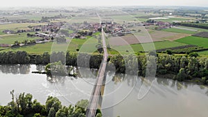 Aerial view with an Italian village located on the bank of a river.