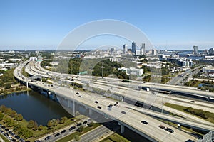 Aerial view of Jacksonville city with high office buildings and american freeway intersection with fast moving cars and