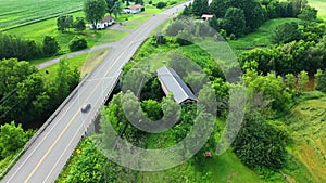 Aerial view of Joseph Edouard Perrault Covered Bridge in Quebec, Canada 4k