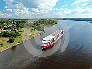 Aerial view journey by passenger cruise ship on the river. Beautiful panoramic landscape from a height ship sails along a river