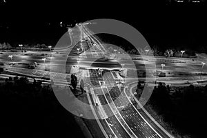 Aerial view at junctions of city highway. Vehicles drive on road