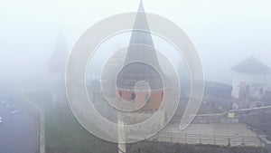 Aerial view of Kamianets-Podilskyi castle in Ukraine under the fog