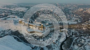 Aerial view of Kamianets-Podilskyi castle in Ukraine in winter. The fortress located among the picturesque nature in the