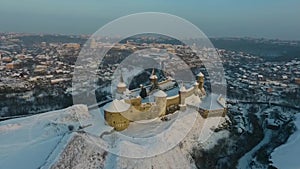 Aerial view of Kamianets-Podilskyi castle in Ukraine in winter. The fortress located among the picturesque nature in the