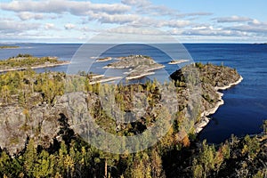  Aerial view of Karelia. Ladoga lake, wooded shores and skerries in autumn. Russia, Karelia