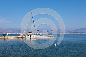 Aerial view of Kassiopi, village in northeast coast of Corfu island, Ionian Islands, Kerkyra, Greece in a summer sunny day, with