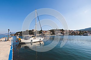 Aerial view of Kassiopi, village in northeast coast of Corfu island, Ionian Islands, Kerkyra, Greece in a summer sunny day, with