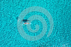 Aerial view of kayak with people in blue sea at summer sunny day