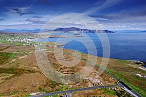 Aerial view on Keel town, Ireland. Warm sunny day. Popular tourist area with beaches and stunning nature scenery. Green grass