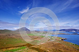 Aerial view on Keel town, Ireland. Warm sunny day. Popular tourist area with beaches and stunning nature scenery. Green grass