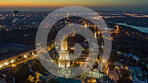 Aerial view of Kiev Pechersk Lavra at sunset hour with illumination. Flying over Kyiv-Pechersk Lavra Orthodox Monastery