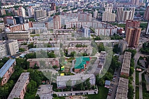 Aerial view of Kindergarten in area in the city with a lot of buildings and skyscrapes. Russian streets, Novosibirsk