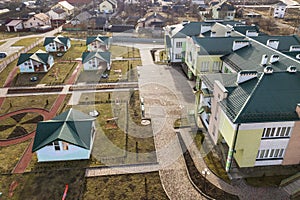 Aerial view of kindergarten or modern school complex, decorated building roofs and colorful playground on sunny yard