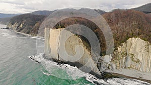 Aerial view of Kiseleva rock, Krasnodar Territory. People are standing on top of cliff. Rock consists of white slabs and