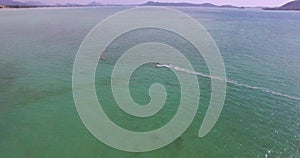 Aerial view kite surfing in tropical blue ocean 4K