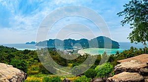 Aerial view of Ko Phi Phi islands, Thailand. Lookout from the viewpoint to tropical island, beach and ocean with long tail boats.