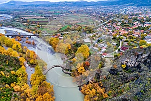 Aerial view of Konitsa old bridge and Aoos River an autumn day,