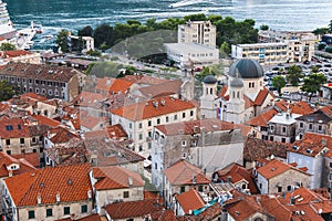 Aerial view of the Kotor harbour,  old town rooftops,  Church of St. Nicholas and marina. Boka Kotorska, Montenegro.