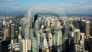 Aerial view of Kuala Lumpur skyline with skyscrapers and mountains in the background