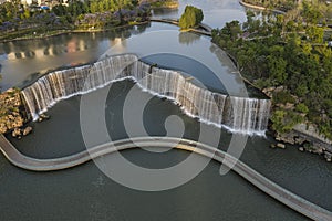 Aerial view of the Kunming Waterfall Park at sunset, one of the largest manamde waterfalls in the world