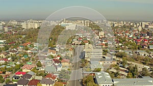 Aerial view of Kyrgyz private houses and concrete boxes of high-rise buildings. Flying over the capital of Kyrgyzstan