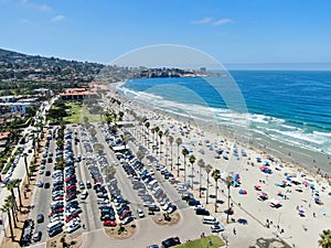 Aerial view of La Jolla bay with nice small waves and tourist enjoying the beach and summer day