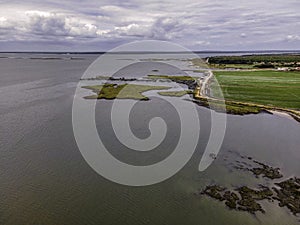 Aerial view of a lagoon with a flooded field suring the high tide at Porto Palafita da Carrasquiera along the river in Comporta, photo