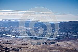 Aerial view of Laguna Lake, San Luis Obispo, California; the Pacific ocean coastline covered by a layer of fog in the background