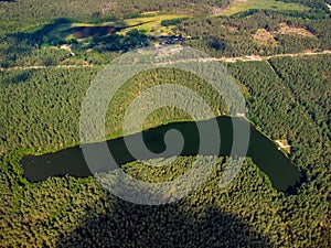 Aerial view of a lake in the forests of Lithuania, wild nature.