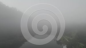 Aerial view of a lake and green nature in mist, Australia