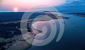 Aerial view of lake Kariba and surrounding landscape, in late evening with setting sun. Blue and pink colors. Zimbabwe wilderness