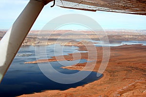 Aerial View of the Lake Powell with the house-boats marina and buttes on the shores