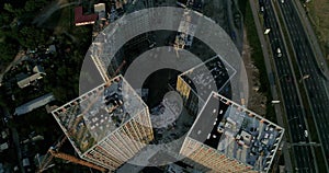 Aerial view of landscape in the city with under construction buildings and industrial cranes.