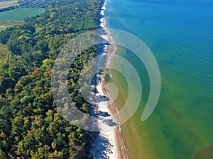 Aerial view on landscape with sea, sand beach and green forest.