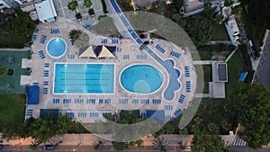 Aerial view of a landscape with a swimming pool surrounded by trees