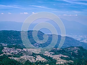 Aerial view landscape of tropical plantation on the hill with Mount Ungaran background