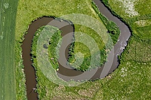 Aerial view landscape of winding river in green field