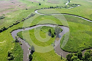 Aerial view landscape of winding river in green field