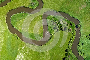 Aerial view landscape of winding river in green field