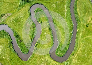 Aerial view landscape of winding river in green field