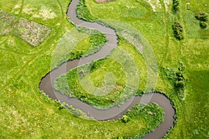 Aerial view landscape of winding river in green field