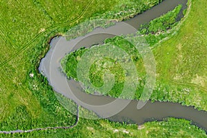 Aerial view landscape of winding river in green field