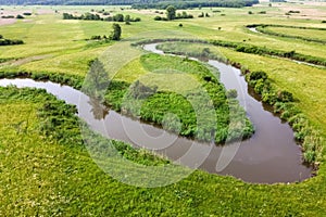 Aerial view landscape of winding river in green field