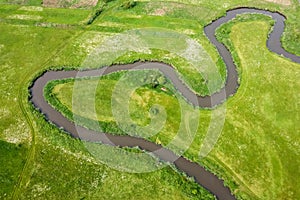 Aerial view landscape of winding river in green field