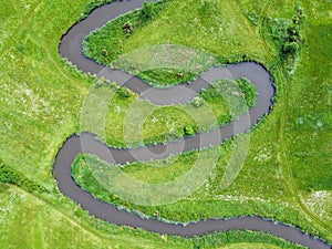 Aerial view landscape of winding river in green field